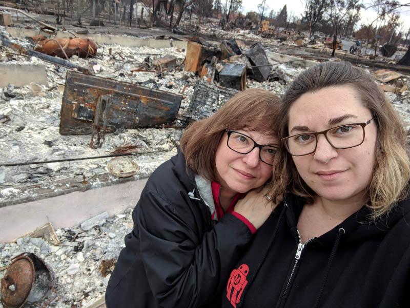 Melissa Geissinger (left) and her mother, Nancy Crain, stand in front of the charred remains of Geissenger's Santa Rosa, California neighborhood. (Photo courtesy of Melissa Geissinger)